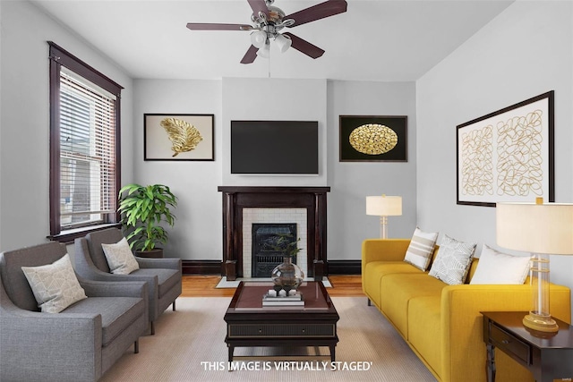 living room with ceiling fan and light hardwood / wood-style flooring