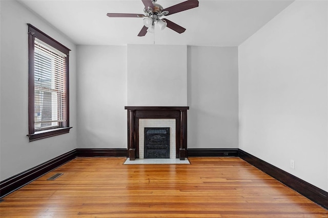 unfurnished living room with ceiling fan and light hardwood / wood-style floors