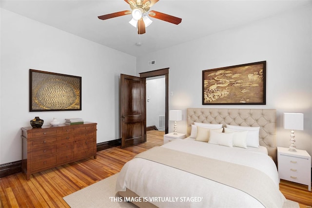 bedroom with light hardwood / wood-style floors and ceiling fan