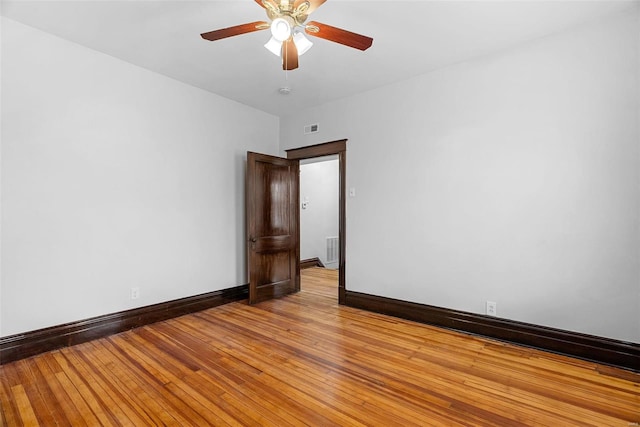 unfurnished room with ceiling fan and light wood-type flooring