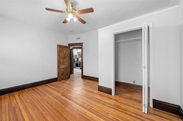 unfurnished bedroom featuring a closet, ceiling fan, and light hardwood / wood-style flooring