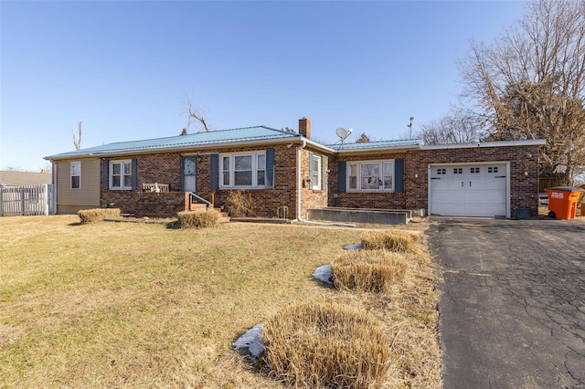 ranch-style house with a garage and a front lawn