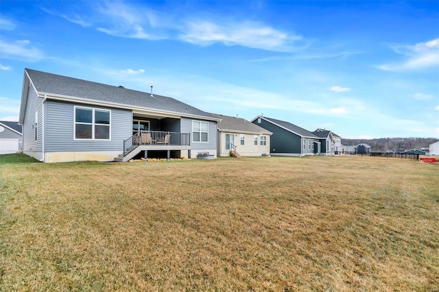 rear view of property with a lawn