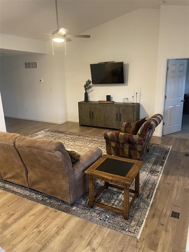 living room featuring ceiling fan, lofted ceiling, and hardwood / wood-style floors