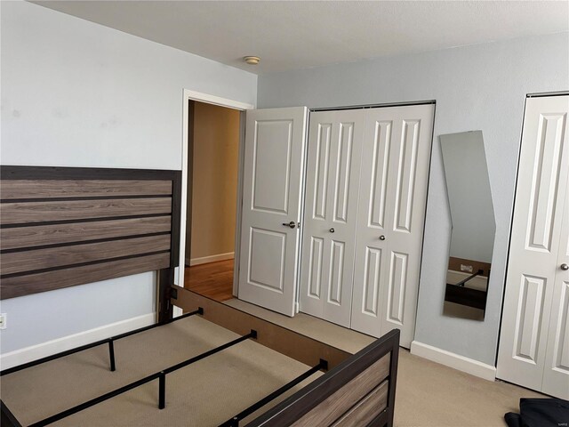 bedroom featuring light carpet and a closet