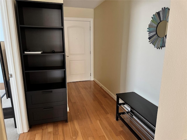 hall with light hardwood / wood-style floors