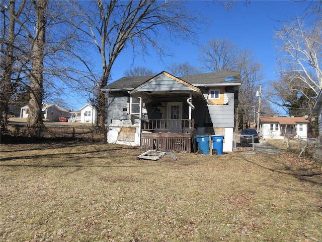 back of house featuring a yard and fence