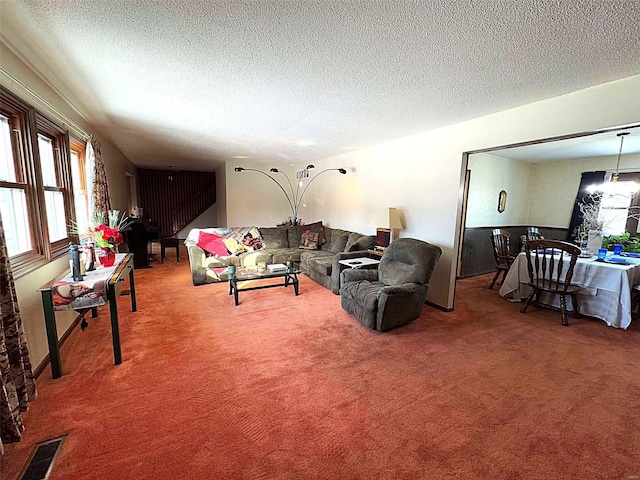 carpeted living room featuring a textured ceiling