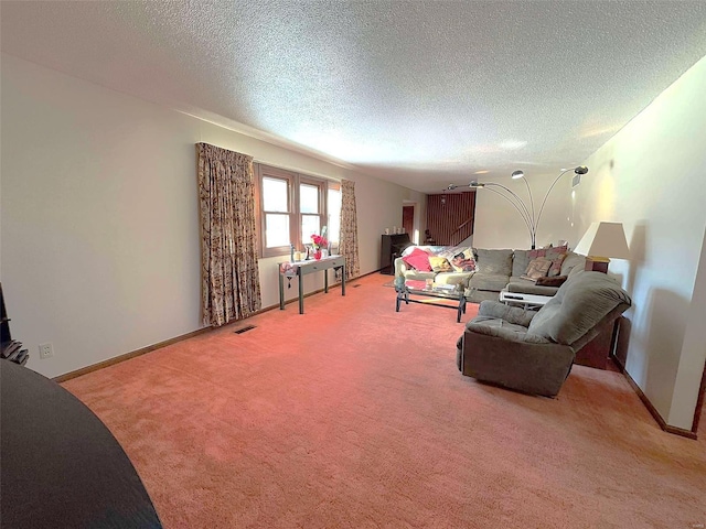 living room featuring light carpet and a textured ceiling