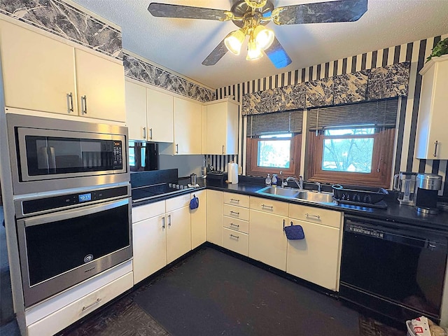 kitchen with sink, ceiling fan, stainless steel appliances, white cabinets, and a textured ceiling