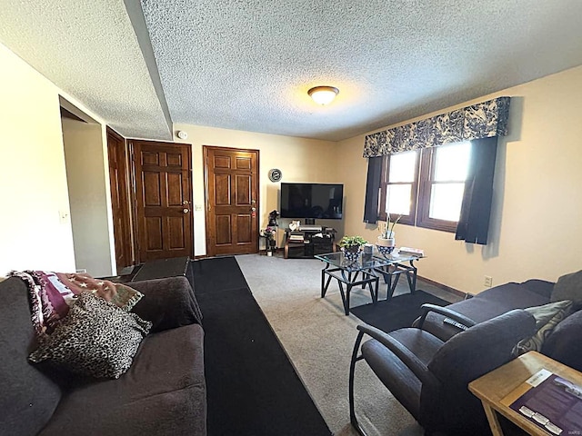 carpeted living room featuring a textured ceiling