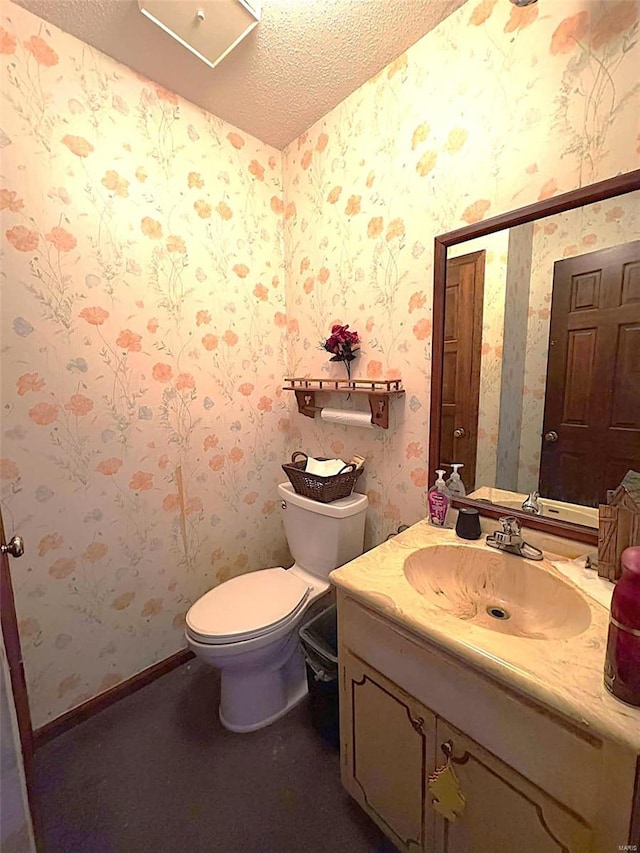 bathroom with vanity, a textured ceiling, and toilet