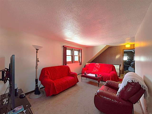 carpeted living room featuring a textured ceiling