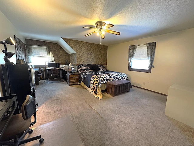 carpeted bedroom with ceiling fan and a textured ceiling