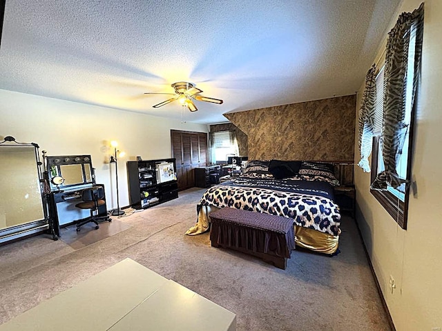 carpeted bedroom with a textured ceiling and ceiling fan