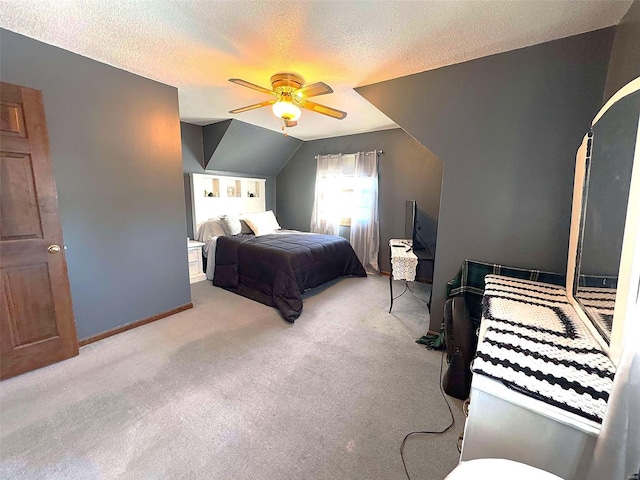 bedroom featuring light carpet, a textured ceiling, lofted ceiling, and ceiling fan