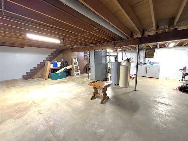 basement featuring heating unit, gas water heater, and washing machine and clothes dryer