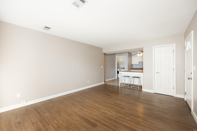 unfurnished living room featuring dark hardwood / wood-style flooring