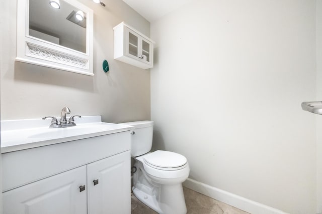 bathroom featuring tile patterned floors, vanity, and toilet