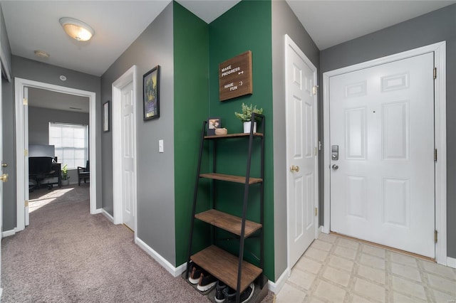 view of carpeted foyer entrance