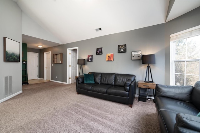 living room with carpet and high vaulted ceiling