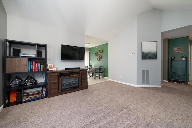 living room with vaulted ceiling and carpet