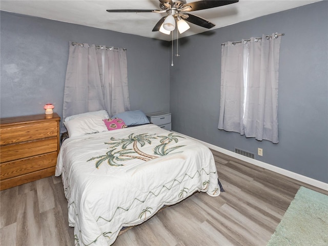 bedroom featuring hardwood / wood-style flooring and ceiling fan