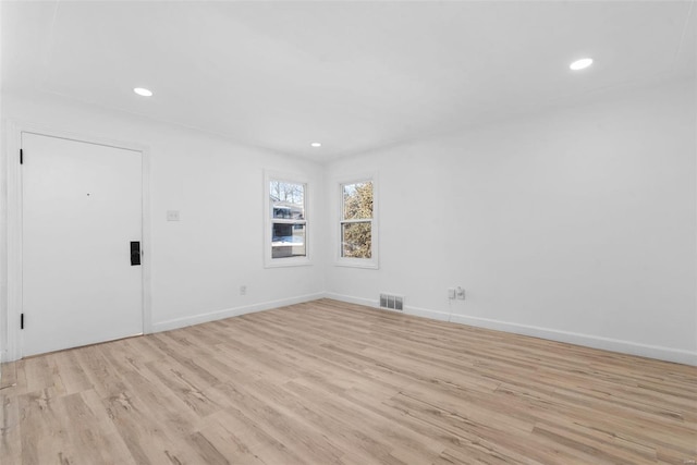 spare room featuring light hardwood / wood-style flooring