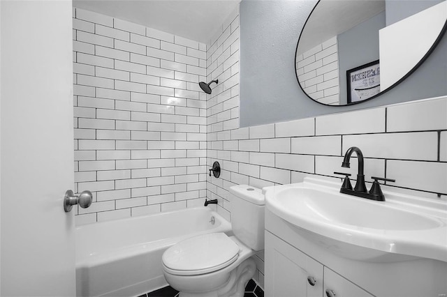 full bathroom featuring tile walls, vanity, toilet, and tiled shower / bath