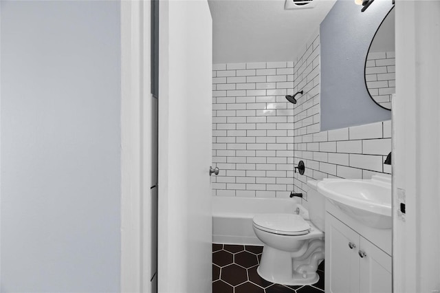 full bathroom with toilet, tile walls, vanity, tiled shower / bath combo, and tile patterned flooring