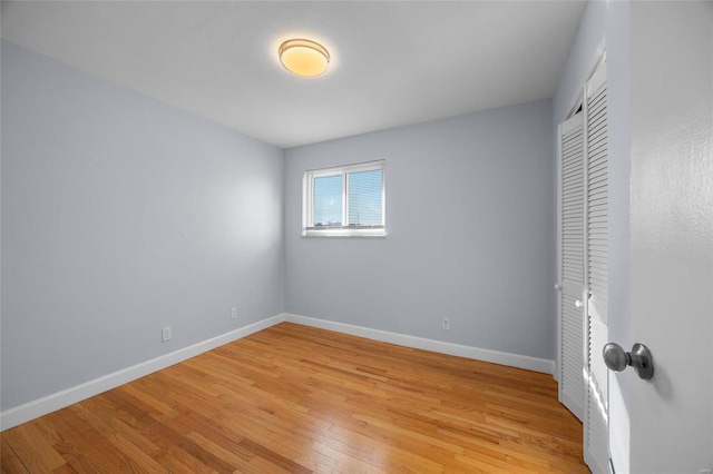 unfurnished bedroom featuring a closet and light hardwood / wood-style flooring