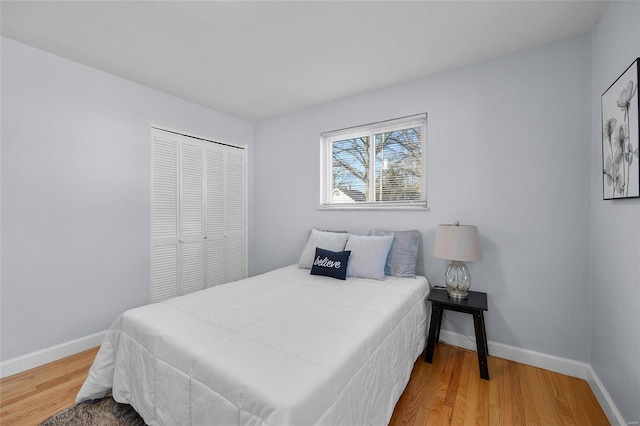 bedroom with wood-type flooring and a closet