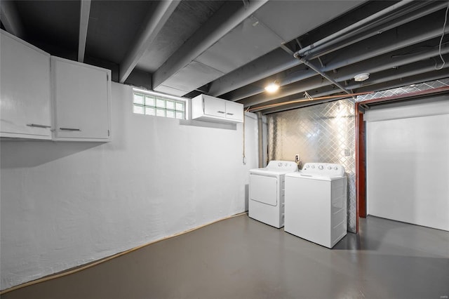 laundry area with cabinets and washing machine and dryer