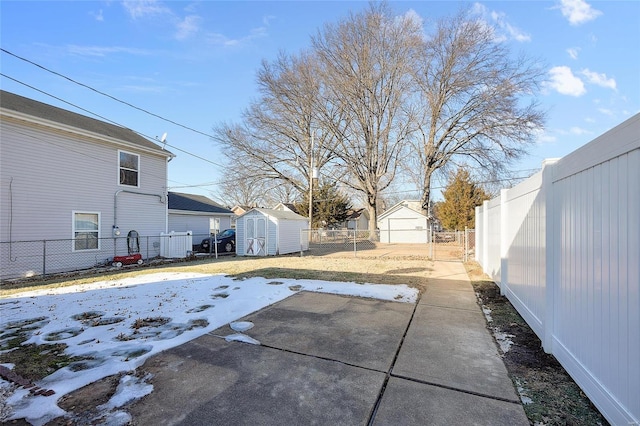 snow covered patio with a storage unit