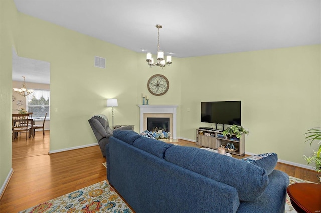 living room featuring hardwood / wood-style floors and a notable chandelier