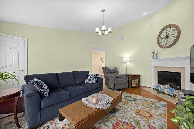 living room with an inviting chandelier and hardwood / wood-style flooring