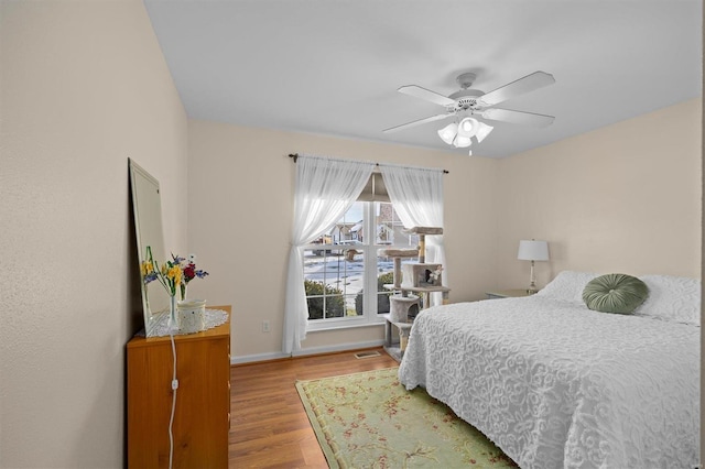 bedroom featuring ceiling fan and light hardwood / wood-style flooring