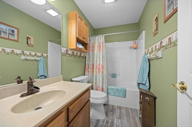 full bathroom featuring vanity, hardwood / wood-style floors, shower / tub combo with curtain, and toilet