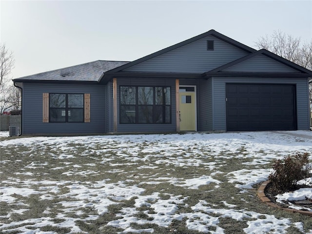 view of front of home featuring a garage and central AC