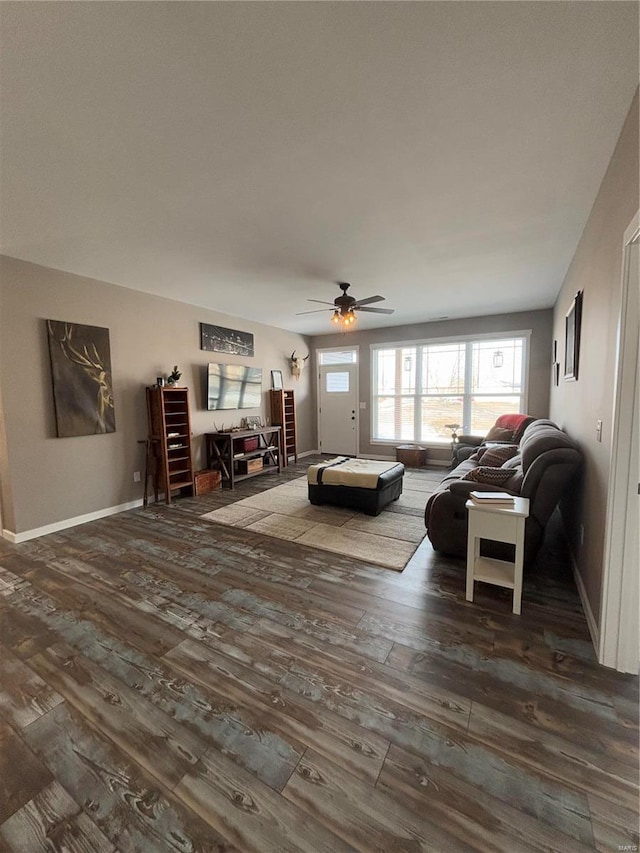 living room with ceiling fan and dark hardwood / wood-style floors