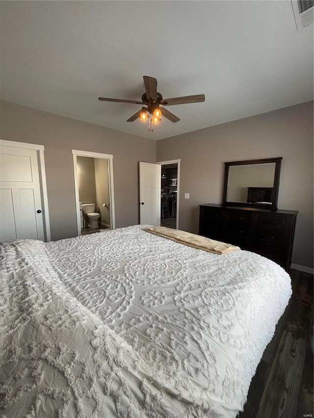 bedroom with ceiling fan, a closet, ensuite bath, and a walk in closet