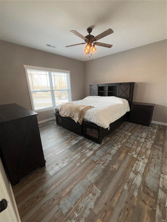 bedroom featuring ceiling fan and dark hardwood / wood-style floors