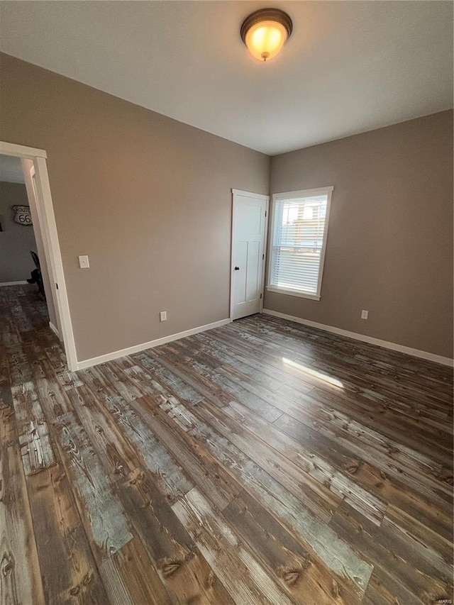 spare room featuring dark hardwood / wood-style floors