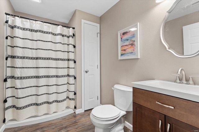 full bathroom featuring vanity, wood-type flooring, shower / bath combination with curtain, and toilet