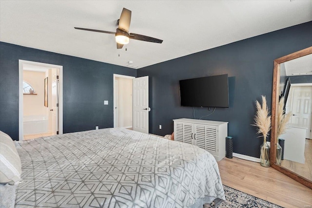 bedroom with light hardwood / wood-style flooring, ceiling fan, and ensuite bathroom