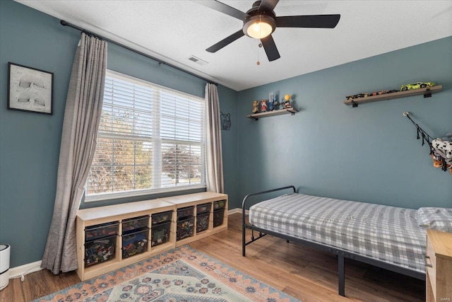 bedroom featuring hardwood / wood-style floors and ceiling fan