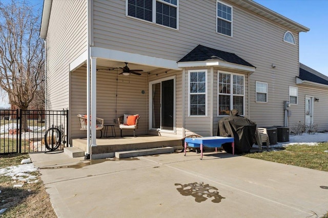 back of property featuring ceiling fan and a patio