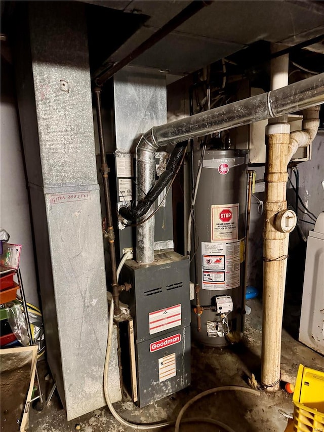 utility room featuring gas water heater and washer / clothes dryer