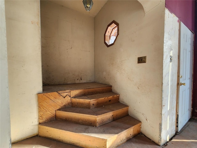 staircase with concrete flooring