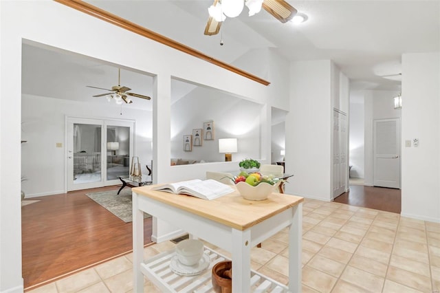 kitchen featuring light tile patterned flooring, white cabinetry, and ceiling fan